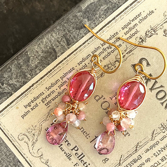 Bright fuchsia quartz and pink topaz chandelier earrings photographed on the vintage soap box