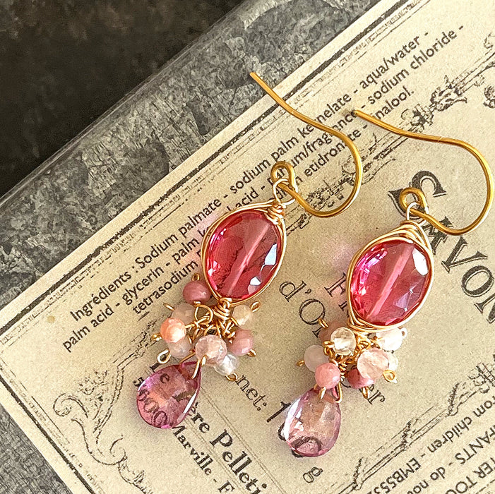 Bright fuchsia quartz and pink topaz chandelier earrings photographed on the vintage soap box