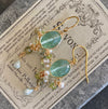 Pair of sea blue quartz oval shape chandelier earrings on the vintage french soap tin box