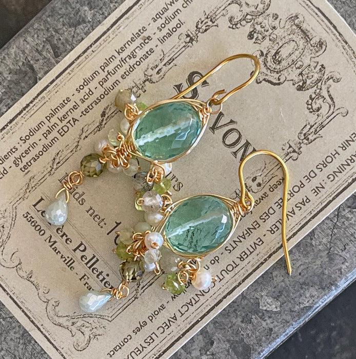 Pair of sea blue quartz oval shape chandelier earrings on the vintage french soap tin box
